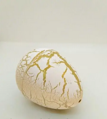 Яйцо с динозавром Орбиз (из гидрогеля, растушка) бело-золотое 4,5x6 см (40404)